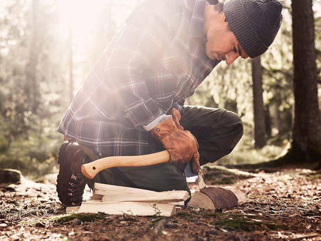 A person in the forest with a Hultafors axe with ovako steel in it